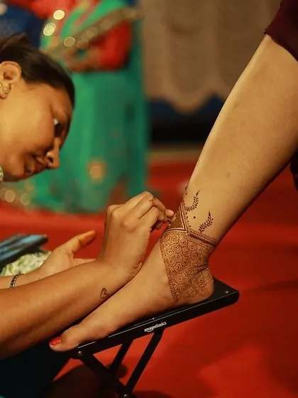 Here I am, focused on creating a detailed design for a client. My 12+ years of professional experience inform every lesson I teach, ensuring you learn practical skills that are valuable for real world mehendi application.