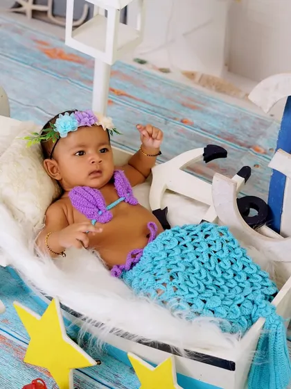 Another angle from the nautical mermaid session, capturing the baby looking off to the side. The setup is designed to be interesting from every viewpoint for a variety of shots.