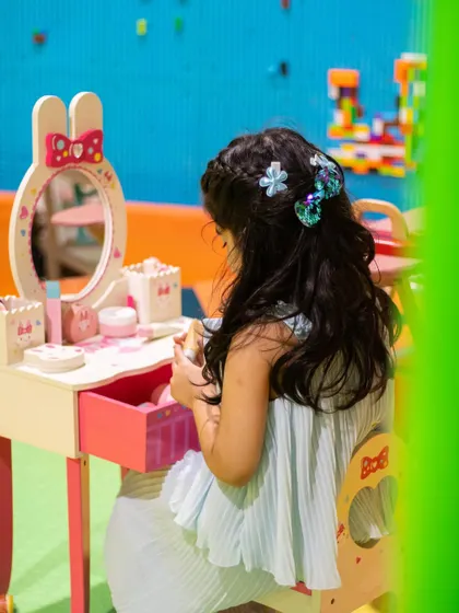 A quiet moment of focus at the play vanity. It's a wonderful corner for kids to express their creativity.