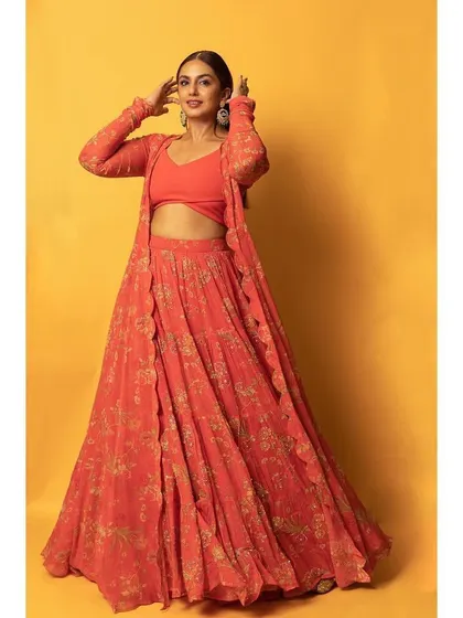 The full view of the orange Paulmi and Harsh lehenga. The three-piece set is versatile and allows for different styling options.