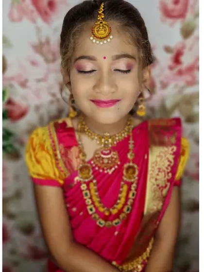 A close-up with her eyes closed, highlighting the soft pink eyeshadow and her sweet, smiling expression.