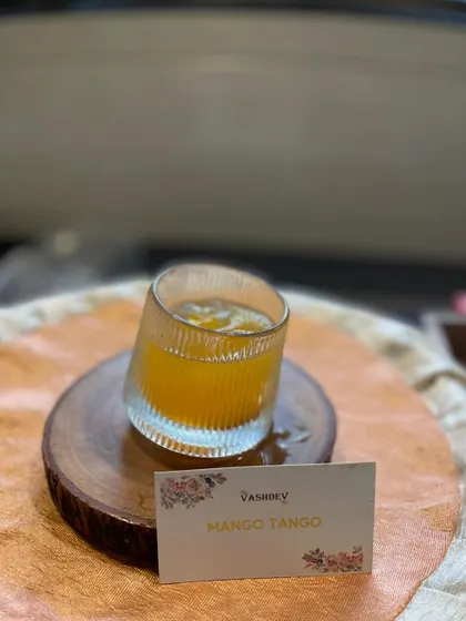 The Mango Tango is a refreshing tropical mocktail, beautifully presented in a modern tilted glass. It's perfect for summer events and outdoor corporate retreats.