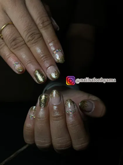 Another perspective of the gold glitter fade nails, highlighting the delicate placement of rhinestones along the cuticle for a polished, professional finish.
