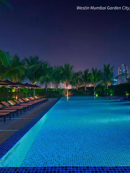 The poolside at Westin Mumbai Garden City at night. The beautiful lighting creates a glamorous and sophisticated atmosphere for an evening event.