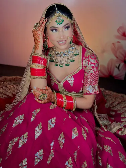 A smiling bride, happy with her final look. The makeup enhances her features and gives her a radiant glow.