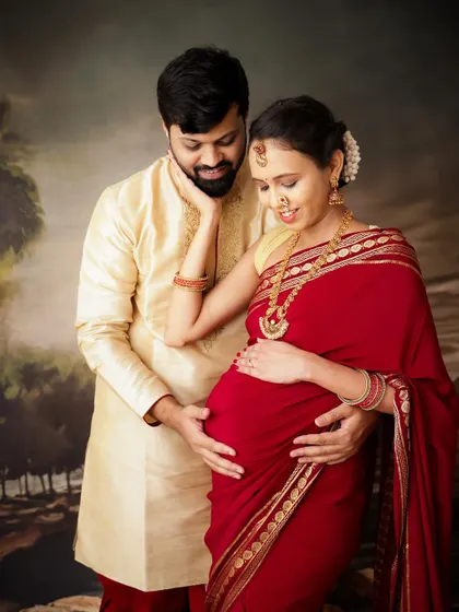 A beautiful traditional maternity portrait. This couple, dressed in ethnic wear, shares a tender moment that honors their cultural heritage.