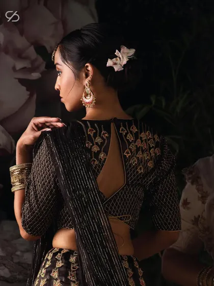 The back of this black and gold blouse is a testament to the artistry of elegant design, a core part of the Sudha Reddy creation.
