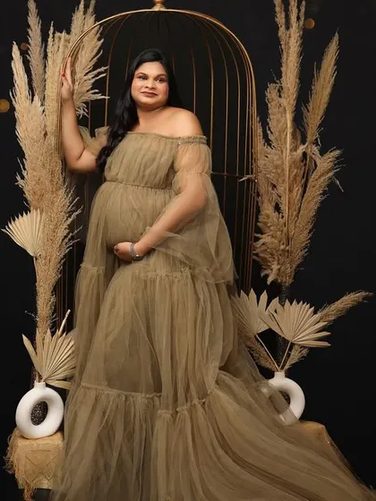 A miracle in the making. This portrait uses a beautiful olive-toned tulle gown and a boho setup with a birdcage to create an earthy yet magical image.