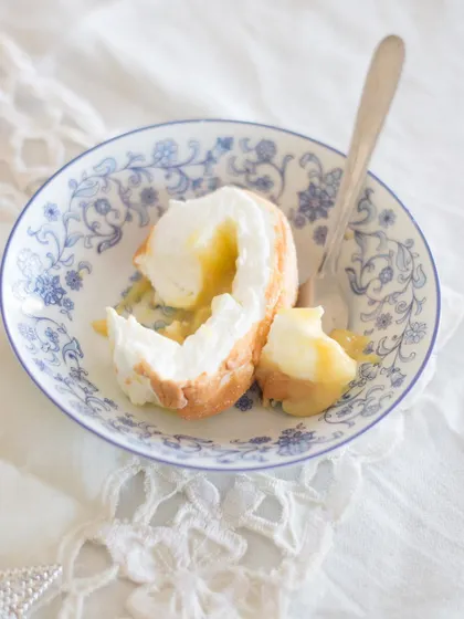 A single, perfect bite of the Brazo de Mercedes. You can see the fluffy, marshmallow-like meringue and the rich, creamy custard filling inside.