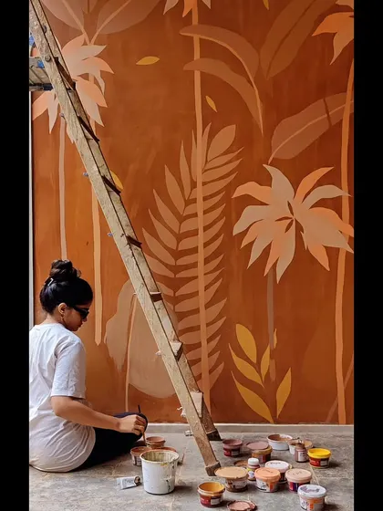 Me at work on this large piece, surrounded by my pots of custom-mixed earthy paints.