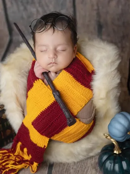Sleeping soundly with his wand, this baby is dreaming of magic.