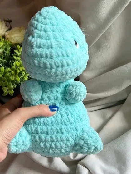Roar! This little blue dinosaur is more cute than scary. Made from soft chunky yarn, it's perfect for small hands to hold during prehistoric adventures.
