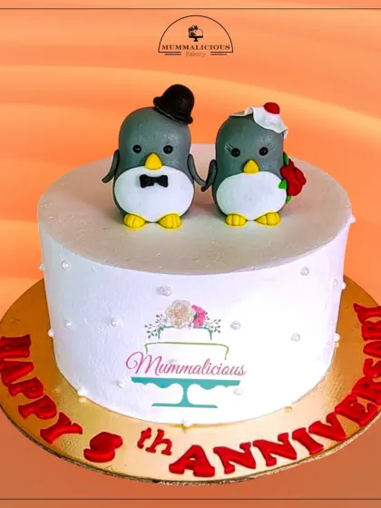 Happy Anniversary! This cute cake with two adorable penguin toppers is a whimsical and sweet way to celebrate your love. The simple, clean design puts the focus on the charming couple.