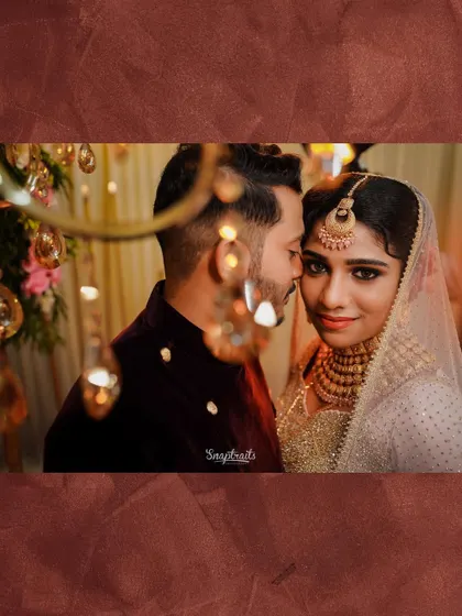 An intimate close-up of the couple, framed by hanging lights that create a magical, romantic bokeh effect.