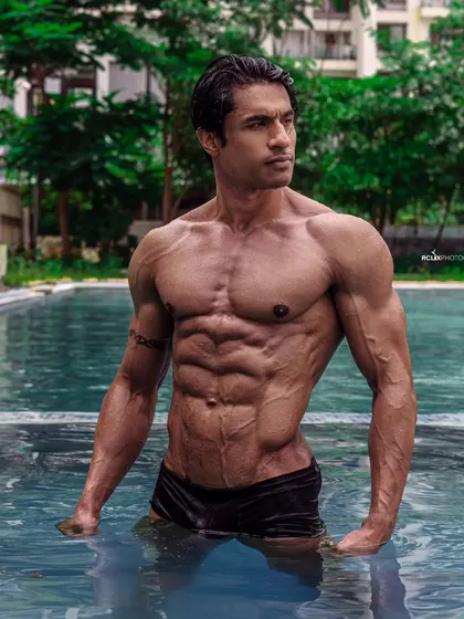 Think less, do more. Fear less, live more. A shredded physique in the pool, representing a life lived to the fullest.