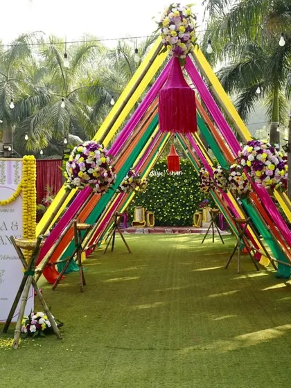 Your signage should feel like a natural part of your decor. At this vibrant Haldi, the welcome board for Riya and Ishaan was designed to complement the colorful ribbon entrance, creating a joyful and picture-perfect welcome.