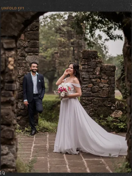 A candid laugh captured within the stone arches of a historic Mumbai location, showing the joy of the moment.