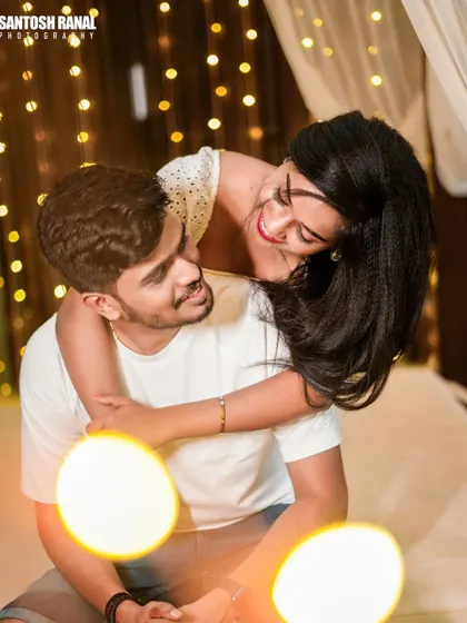 A playful and intimate indoor shot with beautiful bokeh from fairy lights.