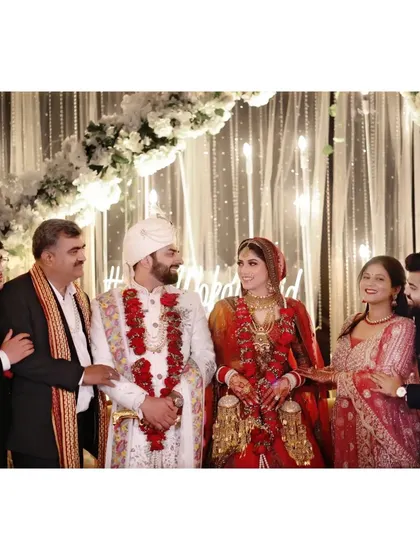 The couple posing with their family, a cherished memory for any wedding album.