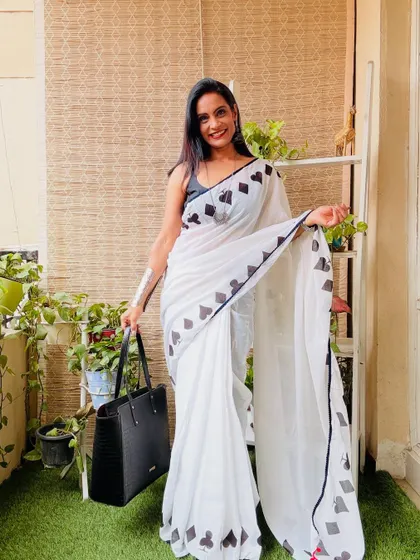 This white cotton mulmul saree with a quirky card suit print is so unique and fun. It's a great conversation starter and a stylish choice for a casual day.