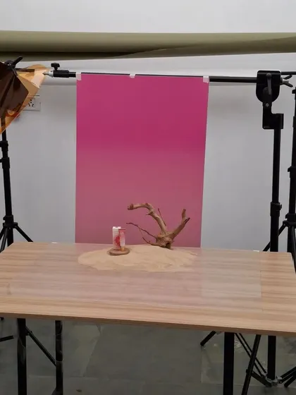 The studio setup for the Mars "Blush Hour" desert scene, showing the gradient background and sand-covered table.