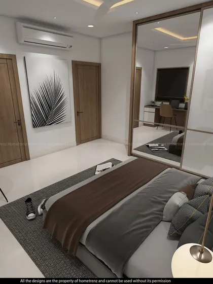 A kids' bedroom with a white and wood-themed wardrobe and study area. The mirrored panels on the wardrobe doors help to brighten the room.