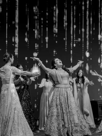 A beautiful black and white shot of the bride and her squad, capturing the joy and freedom in their performance.