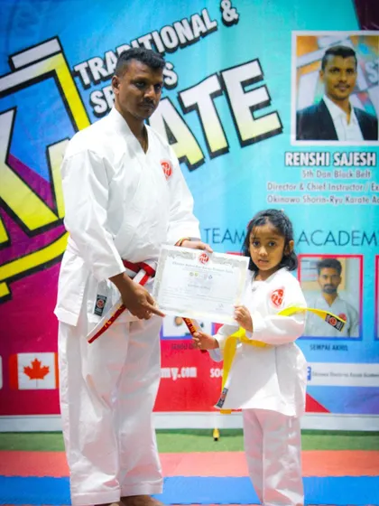 Celebrating the success of one of our youngest members at the belt grading ceremony.