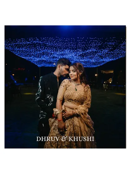 A breathtaking wide shot of the couple under a sky of twinkling fairy lights. This romantic and grand portrait is a perfect end-of-the-night shot for their Sangeet.