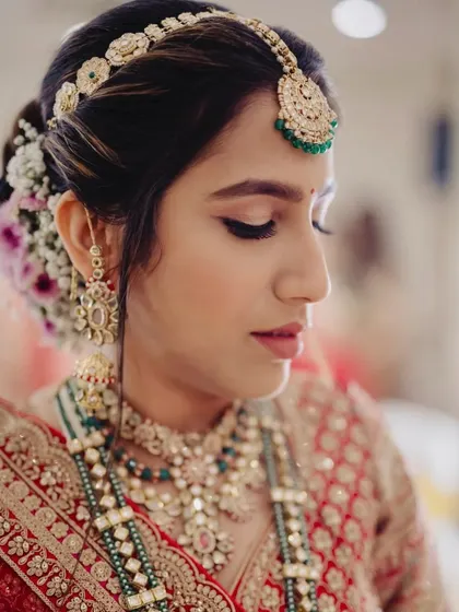A close-up of this bride's serene phera look. The makeup is soft and defined, focusing on her eyes and flawless skin.