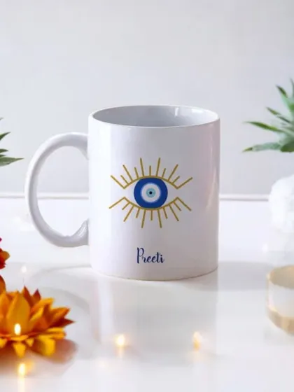 A personalized evil-eye themed mug, perfect for adding a modern and protective touch to your Diwali gifting. The mug can be customized with a name for a personal feel.