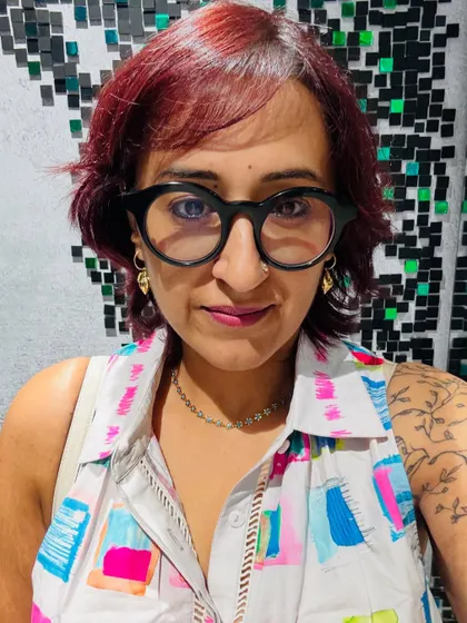 A close-up selfie showing off my floral chain and earrings that I paired with the dress.