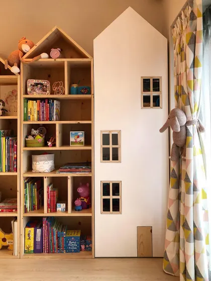These house-shaped bookshelves are one of my signature designs. They turn book storage into a playful display, encouraging kids to pick up a story. This unit is made from natural pine wood.