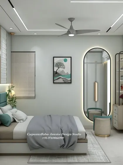 A view of the bedroom showing the large oval mirror and the window, which floods the room with natural light. The design is bright, airy, and elegant.