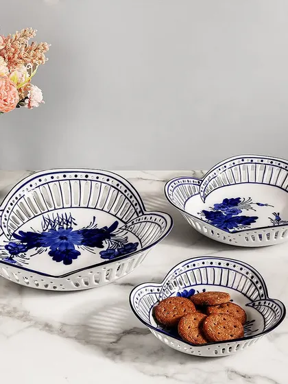 A closer look at the beautiful details of my blue pottery serving bowls. The combination of floral motifs and perforated edges adds a layer of elegance, making them perfect for hosting in style.