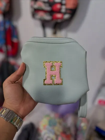 Here is a cute light blue pouch personalized with a pink initial patch. These are great for storing makeup, stationery, or other small essentials.