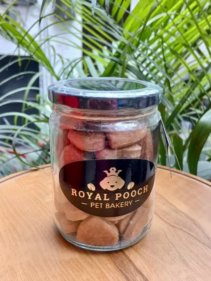 These are my Peanut Butter Chunk Cookies, available in a reusable glass jar. I also offer other flavors like Spinach and Chicken Carrot, all made with the same love and high-quality ingredients.