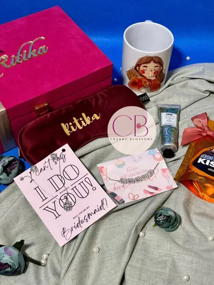 These velvet bridesmaid boxes are pure luxury. Each box is personalised with the bridesmaid's name and filled with a custom mug, eye mask, hand cream, chocolates, and a beautiful bracelet.
