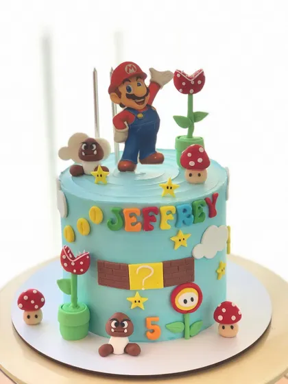 It's-a-me, Mario! This Super Mario themed cake is ready for a birthday adventure, complete with piranha plants, mushrooms, and gold coins.