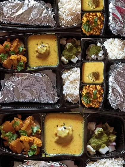 A display of different thali combinations, including kadi with aloo gobhi and kadi with paneer bhurji. There's something for everyone.