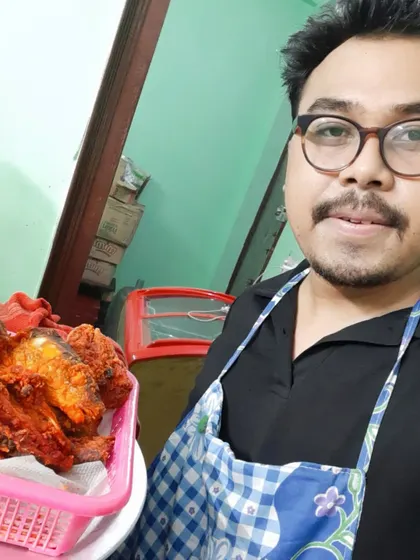 Chef on duty. Here I am with a fresh batch of fried chicken, ready to be packed.