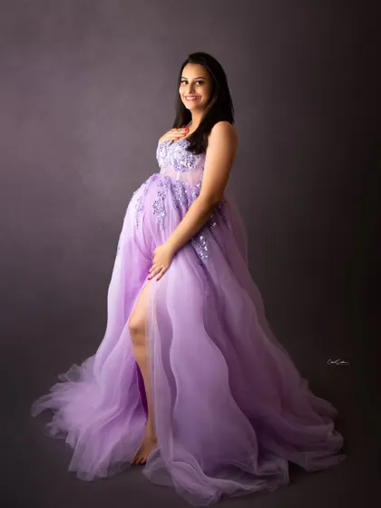 A lovely side profile in a beautiful lavender gown. The thigh-high slit adds a touch of modern glamour to this maternity portrait.