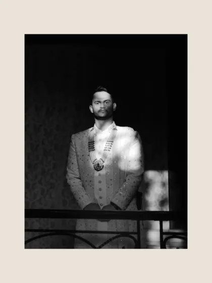 A dramatic black and white portrait of the groom, using light and shadow to create a powerful and timeless image.