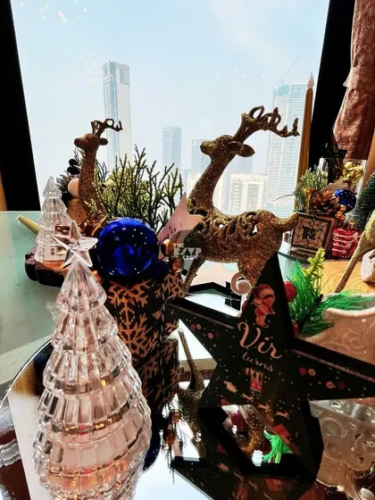 A sparkling Christmas tablescape with glittery reindeer, glass trees, and ornaments.