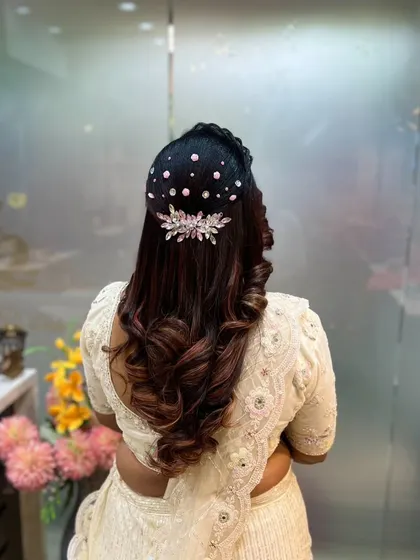 A clearer view of the crystal-studded hairstyle. The placement creates a beautiful, scattered starry effect that adds a touch of magic to the classic curled look.