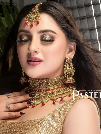 A glamorous shot of a model wearing a red and gold choker, perfect for a festive occasion or a wedding party.
