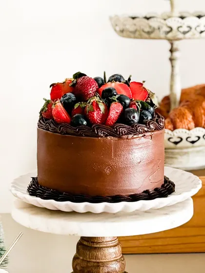 We call this our "Strawberry Symphony". It's a beautiful blend of vanilla, strawberries, and dark chocolate, topped with fresh berries for a cake that truly sings with flavor.