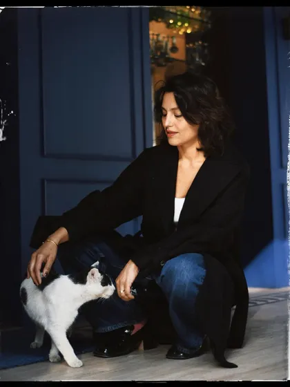 A candid moment between Priya and a friendly cat. The black and white with a film-like border gives it a timeless, storybook feel.
