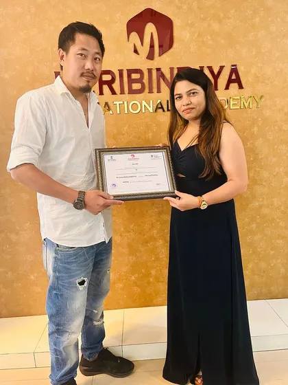 A male student from the Northeast proudly receives his certification, ready to take his skills back home.