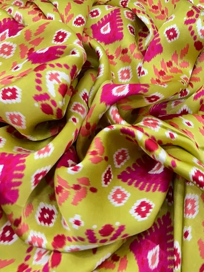 A vibrant lime green modal satin with a pink ikat-inspired print, perfect for those who love to stand out with their style.